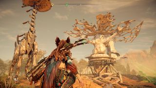 고장난 인공위성 옆에 있는 Tallneck 아래 서 있는 Aloy